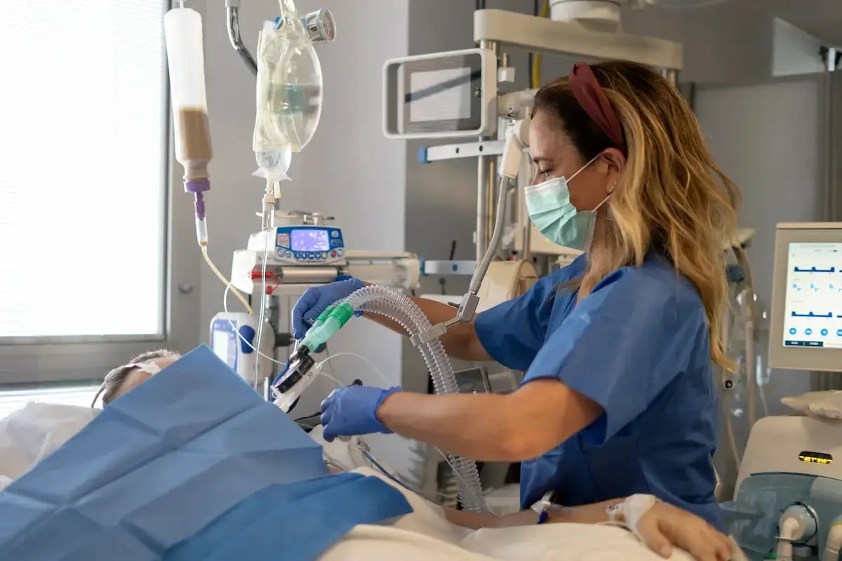 ICU RN using a respiratory device on a patient ICU RN using a respiratory device on a patient