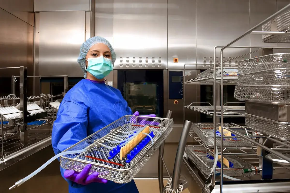 Sterile processing technician cleaning surgery supplies