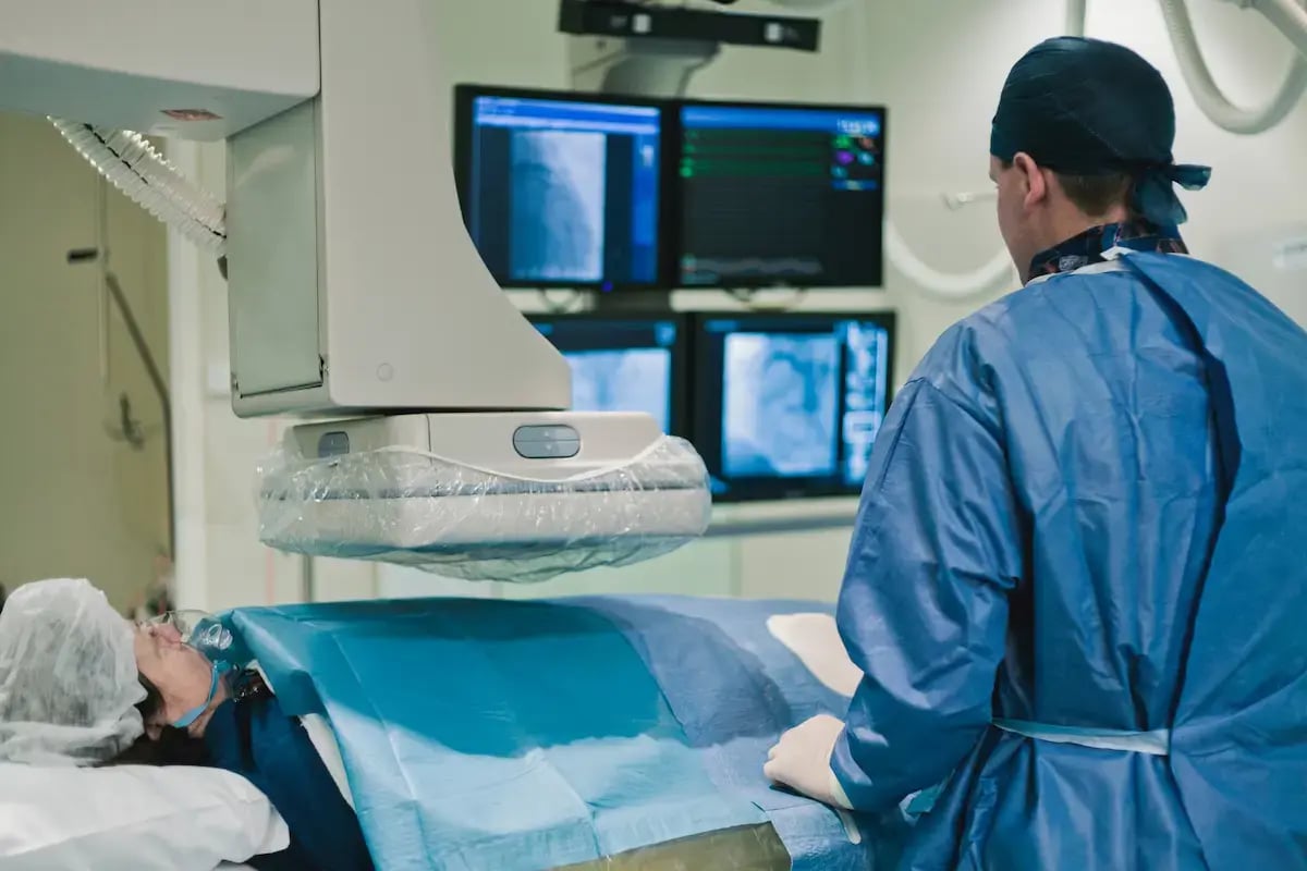 Cardiac cath lab RN scanning a patient's heart Cardiac cath lab RN scanning a patient's heart