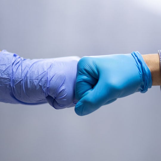 Healthcare workers bumping fists