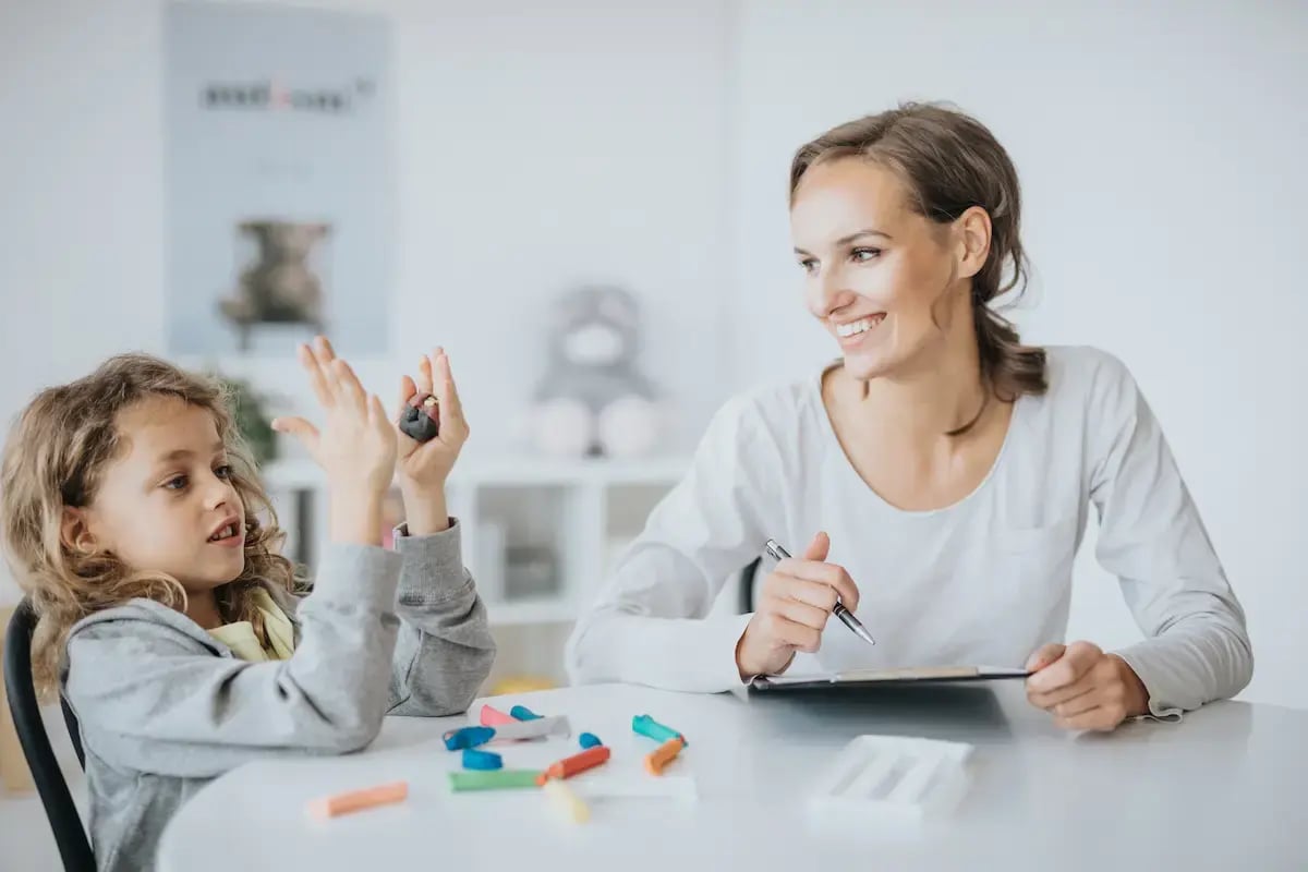Occupational therapy assistant helping a child with their motor skills
