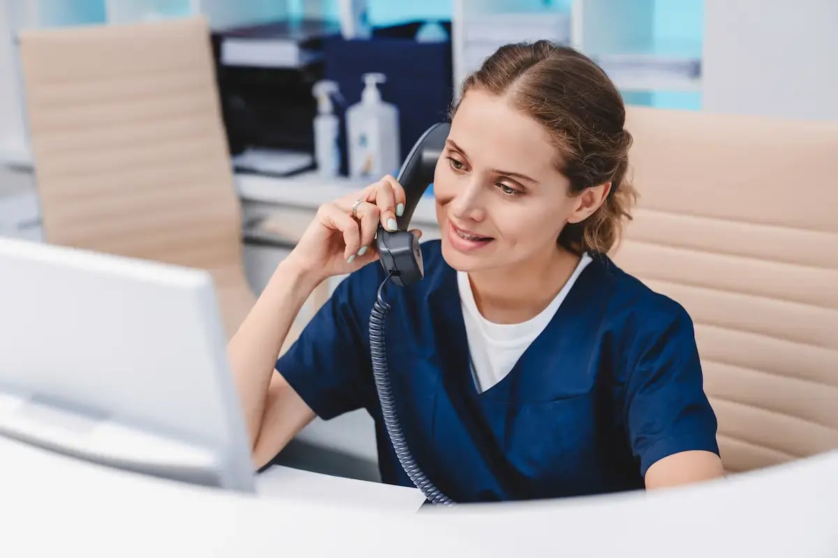 MA answering a phone call at a desk MA answering a phone call at a desk