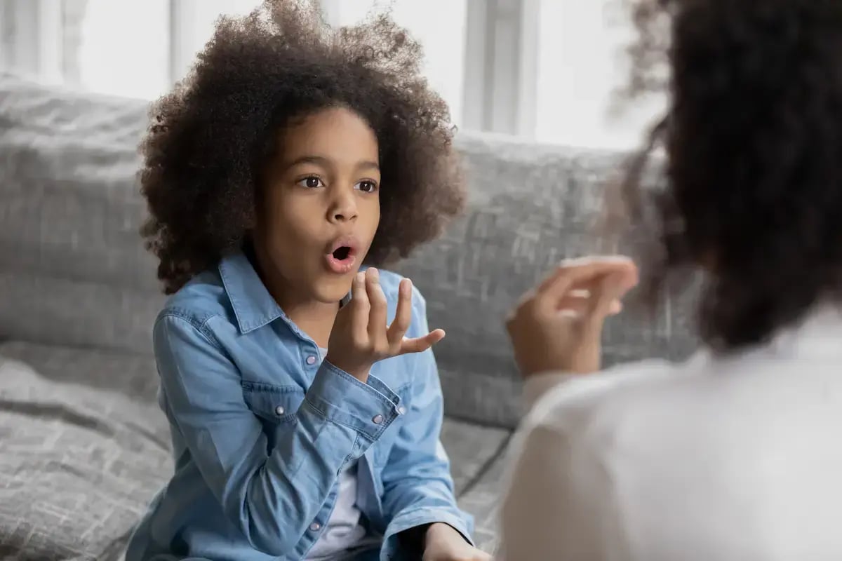 Young patient learning how to pronounce words with a speech therapist