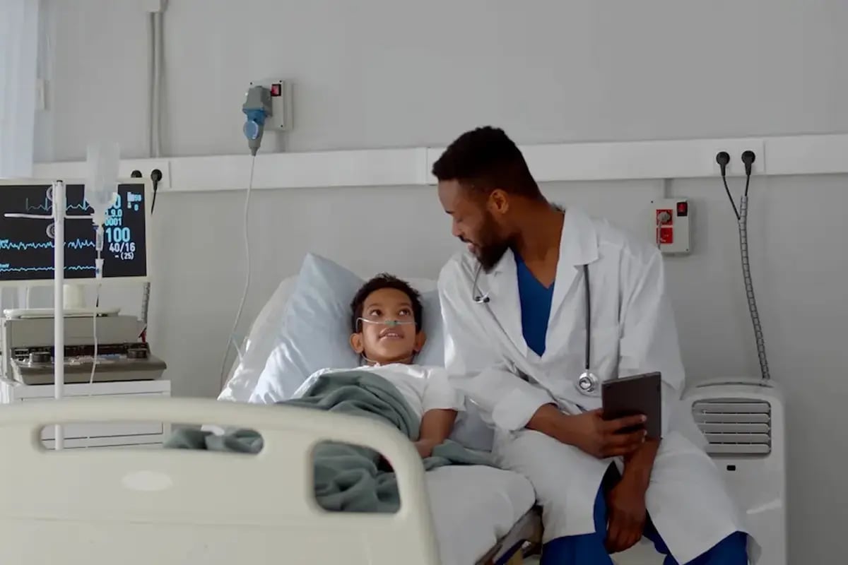 Nurse speaking to to a child patient in the ICU Nurse speaking to to a child patient in the ICU