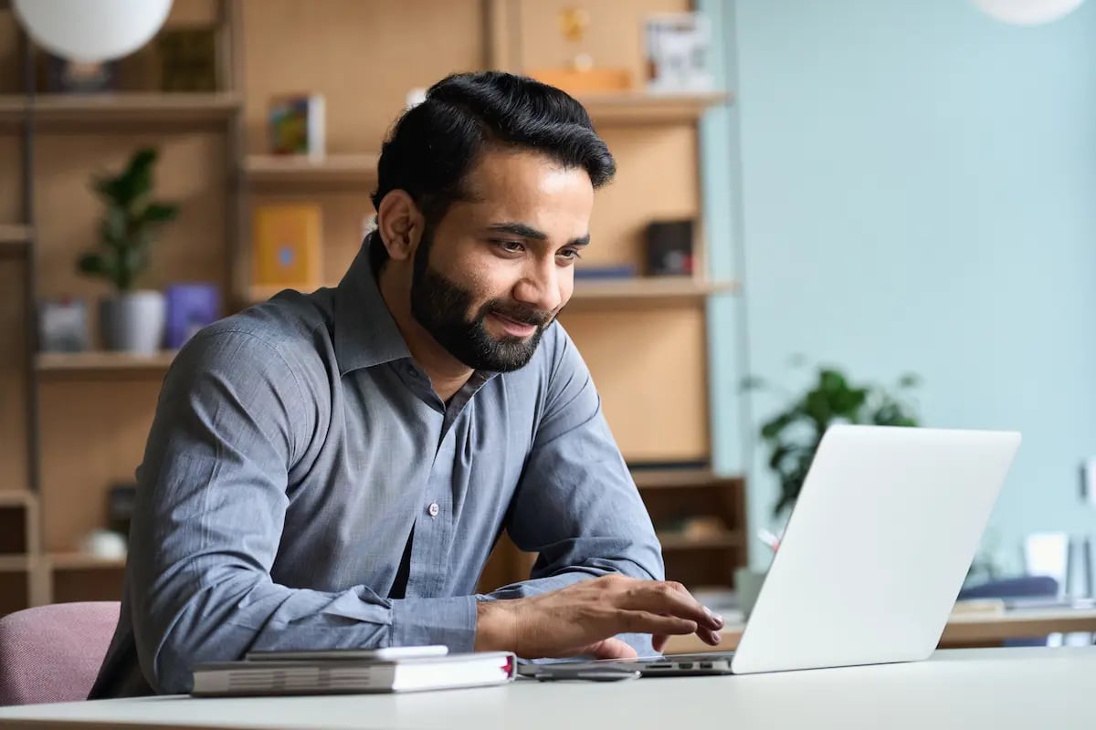 A man using his laptop in an office