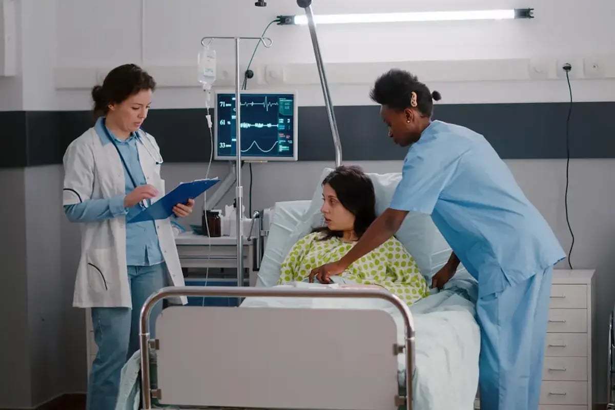 ICU nurses taking care of a patient in bed ICU nurses taking care of a patient in bed