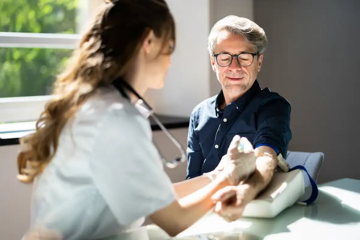 Patient getting their blood drawn by a phlebotomist