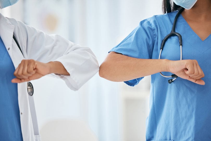 Healthcare workers bumping elbows