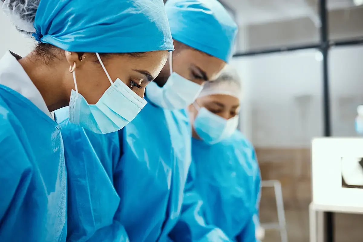 Cath lab RNs wearing masks while working Cath lab RNs wearing masks while working