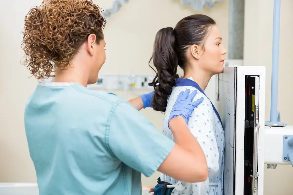 X-ray tech setting up a patient to take an x-ray