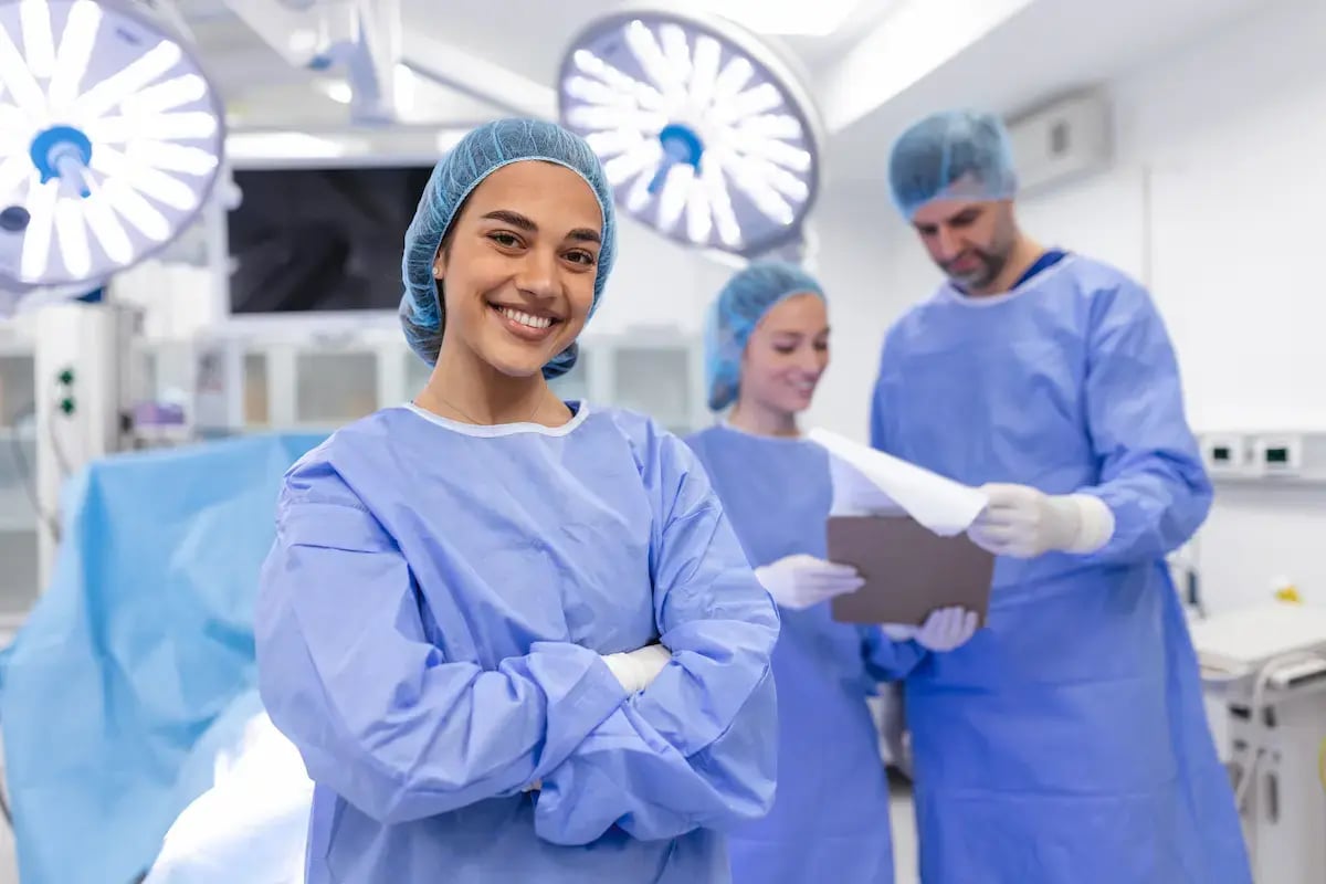 Registered nurse first assistant smiling while in an operating room Registered nurse first assistant smiling while in an operating room