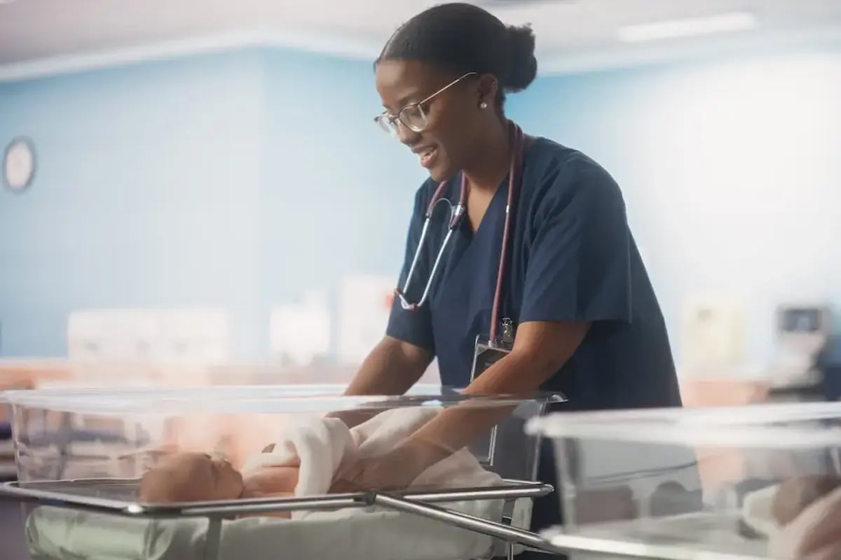 Pediatric ICU RN taking care of a baby in the ICU