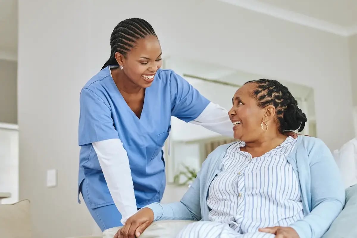 LPN nurse smiling at a patient at a nursing home