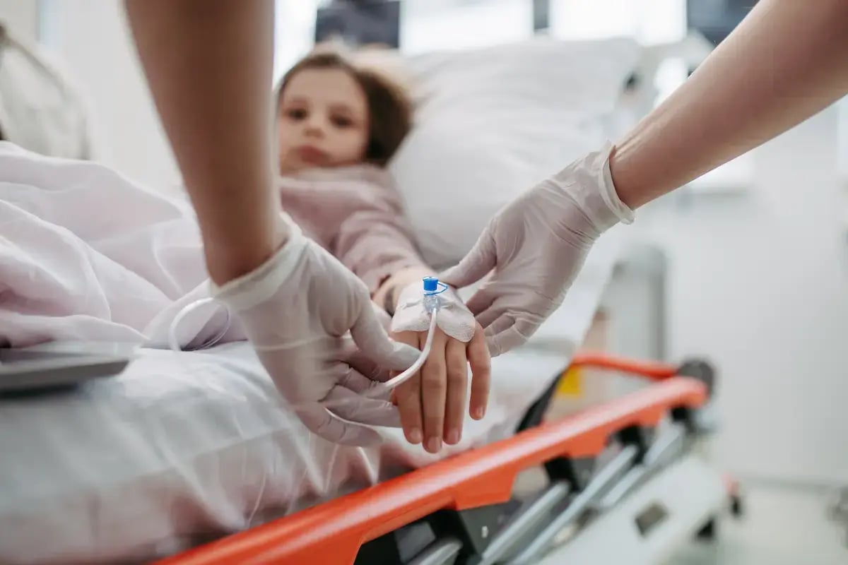 Pediatric ICU nurse putting an IV in a kid's hand Pediatric ICU nurse putting an IV in a kid's hand