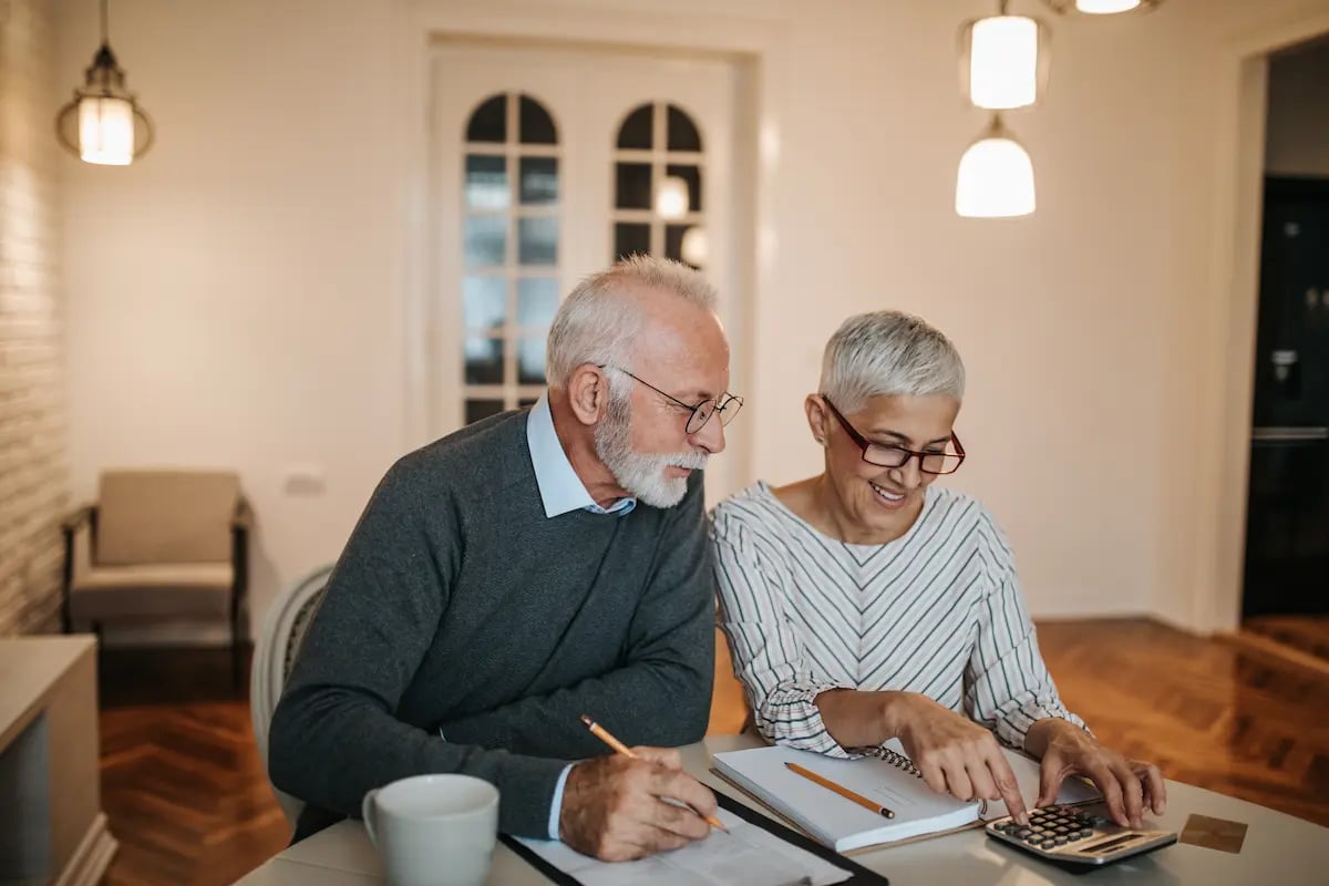 An elderly couple going through their 401k retirement plan while at home