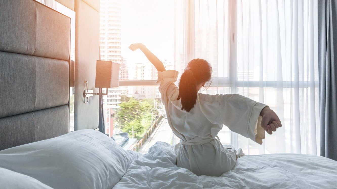 Woman stretching, getting out of bed