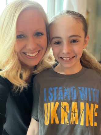 Amanda with her daughter Avery who wears a t-shirt in support of Ukraine.