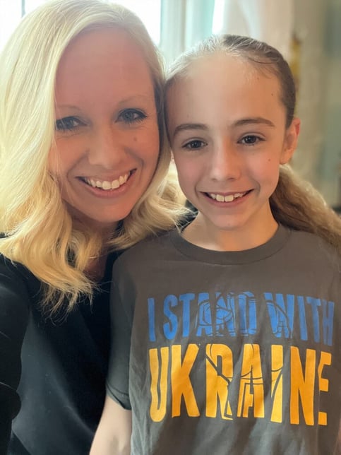 Amanda with her daughter Avery who wears a t-shirt in support of Ukraine.