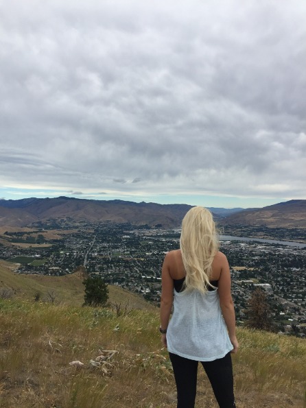 Travel RN stands on a hilltop overlooking Wenatchee, Washington
