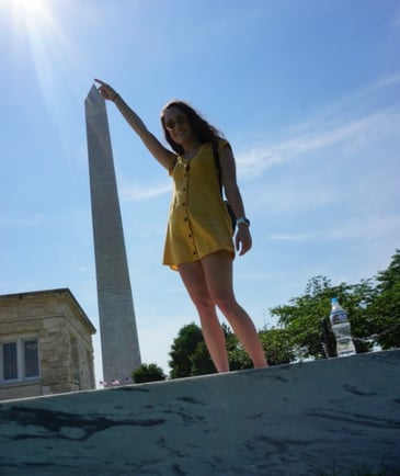 Travel nurse stands in front of the Washington Monument in Washington, DC