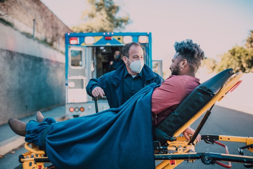 Paramedic helping his patient