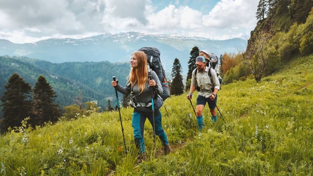 Two hikers walking across a field