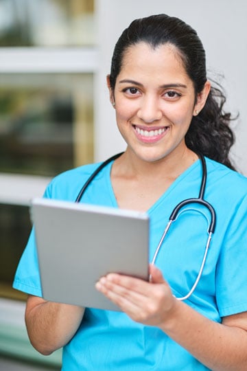 Per diem nurse smiling with a clipboard