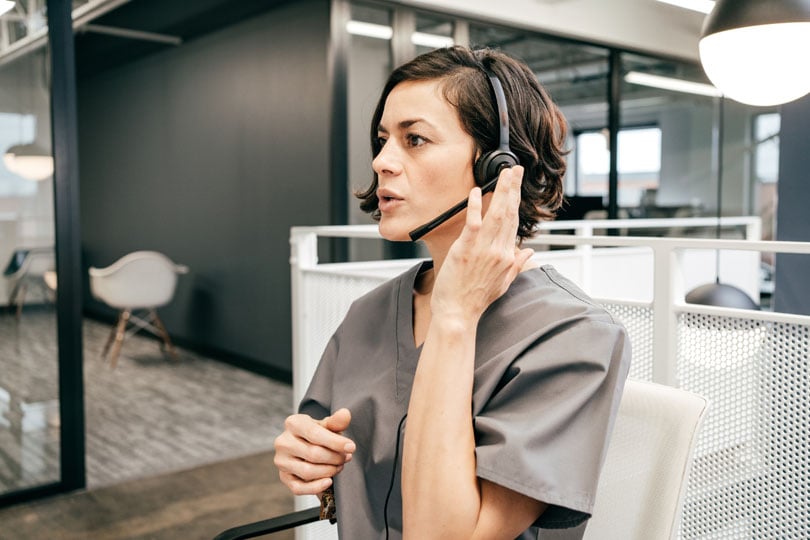 Non-clinical hospital worker on talking on a headset