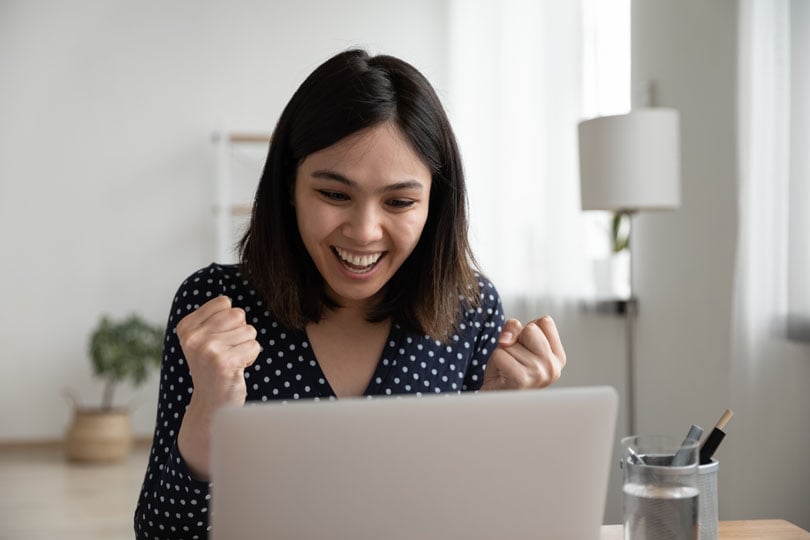 Women smiling at laptop
