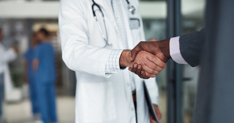 Healthcare workers shaking hands