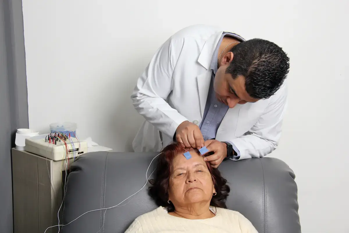 EEG tech putting equipment on a patient