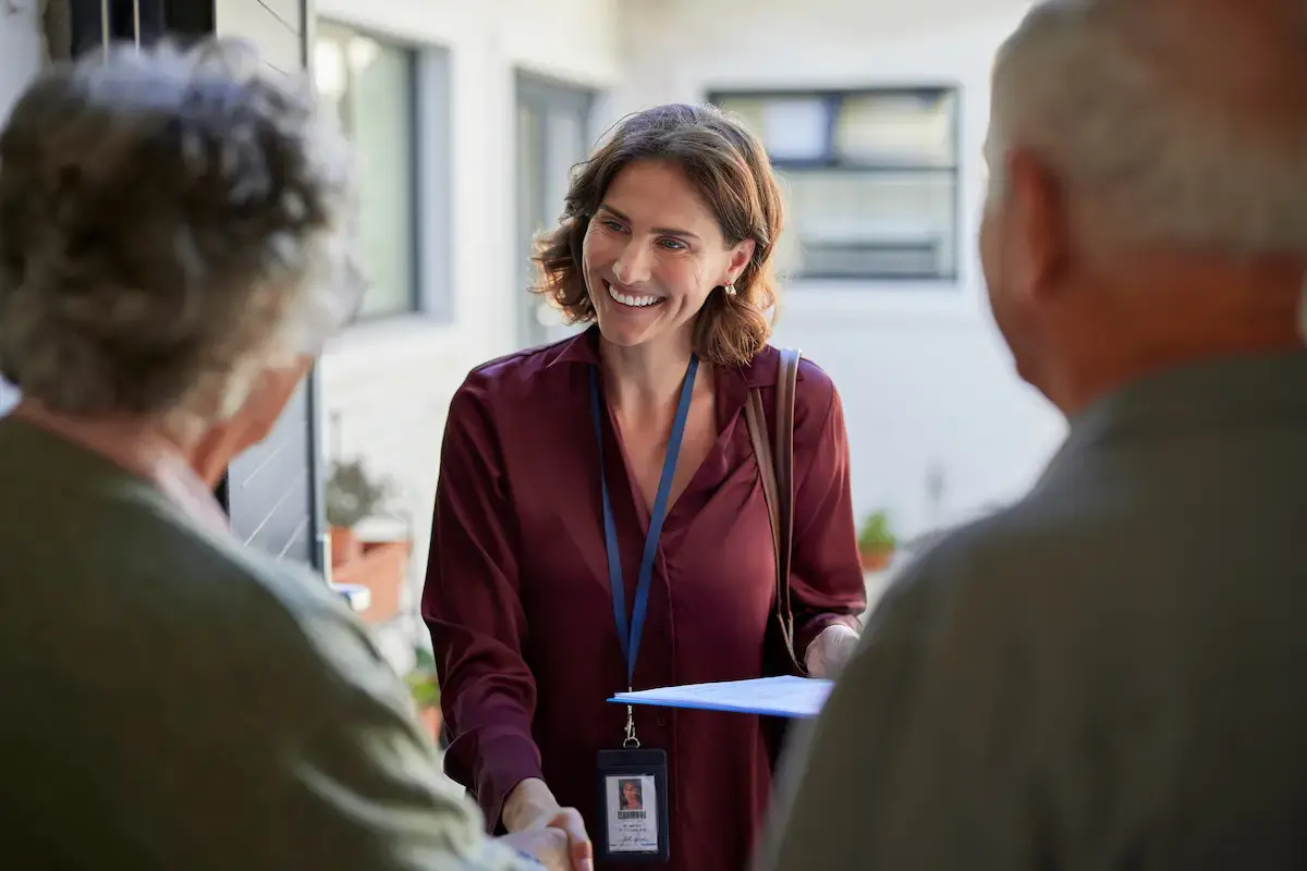 Social worker speaking with an elderly couple
