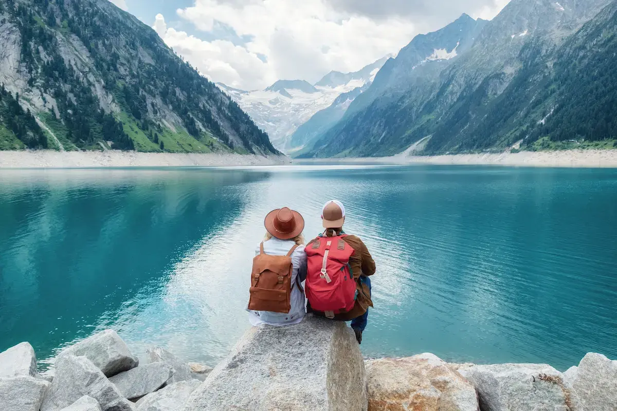 Travel nurses enjoying a lake and mountain view while on a break