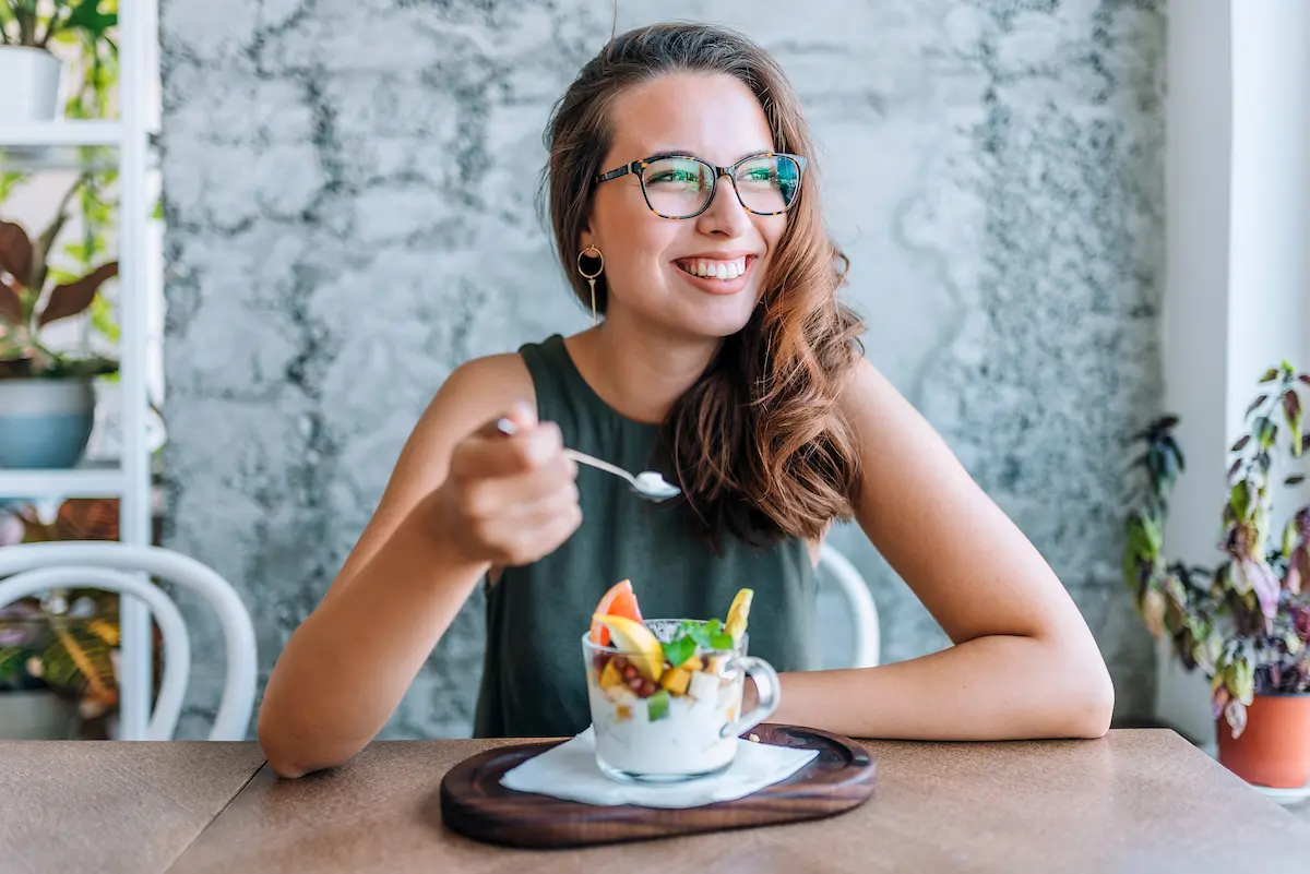 A travel nurse sitting at a table while enjoying a healthy meal