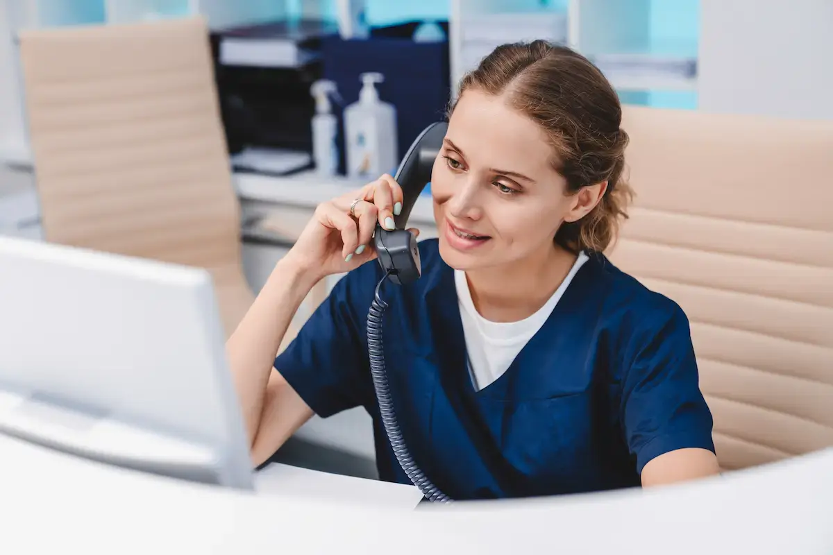 MA answering a phone call at a desk
