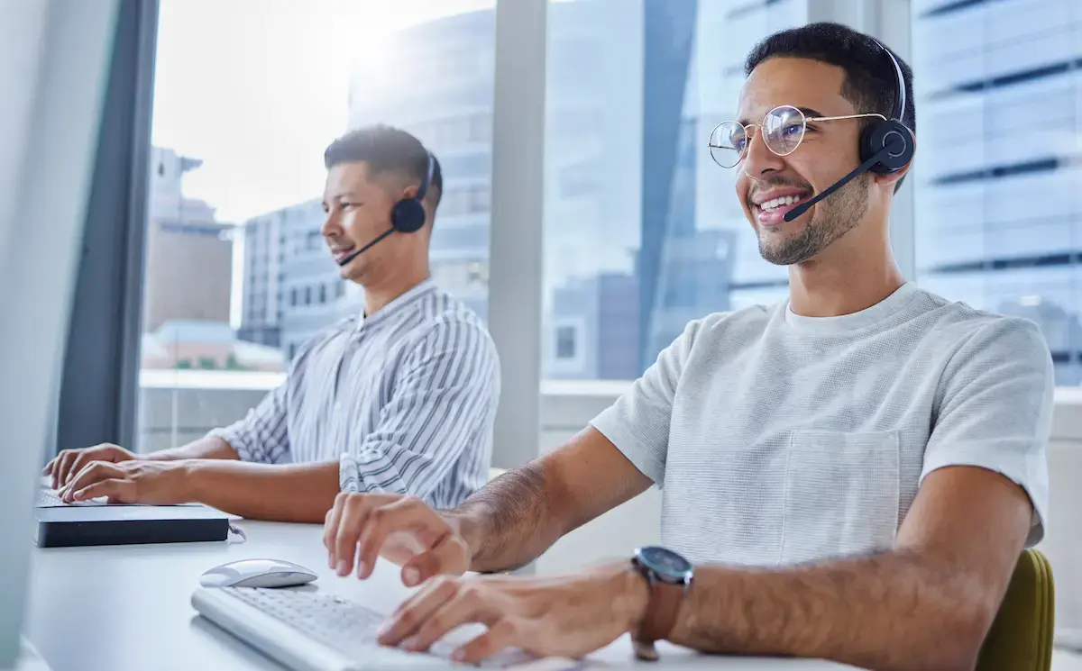 Two non-clinical per diem workers working at a computer in an office