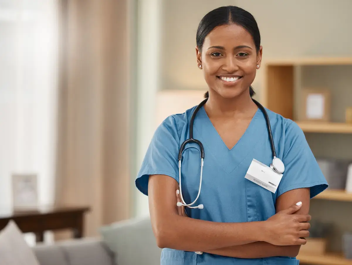 Contract RN smiling and crossing her arms while in a nursing home
