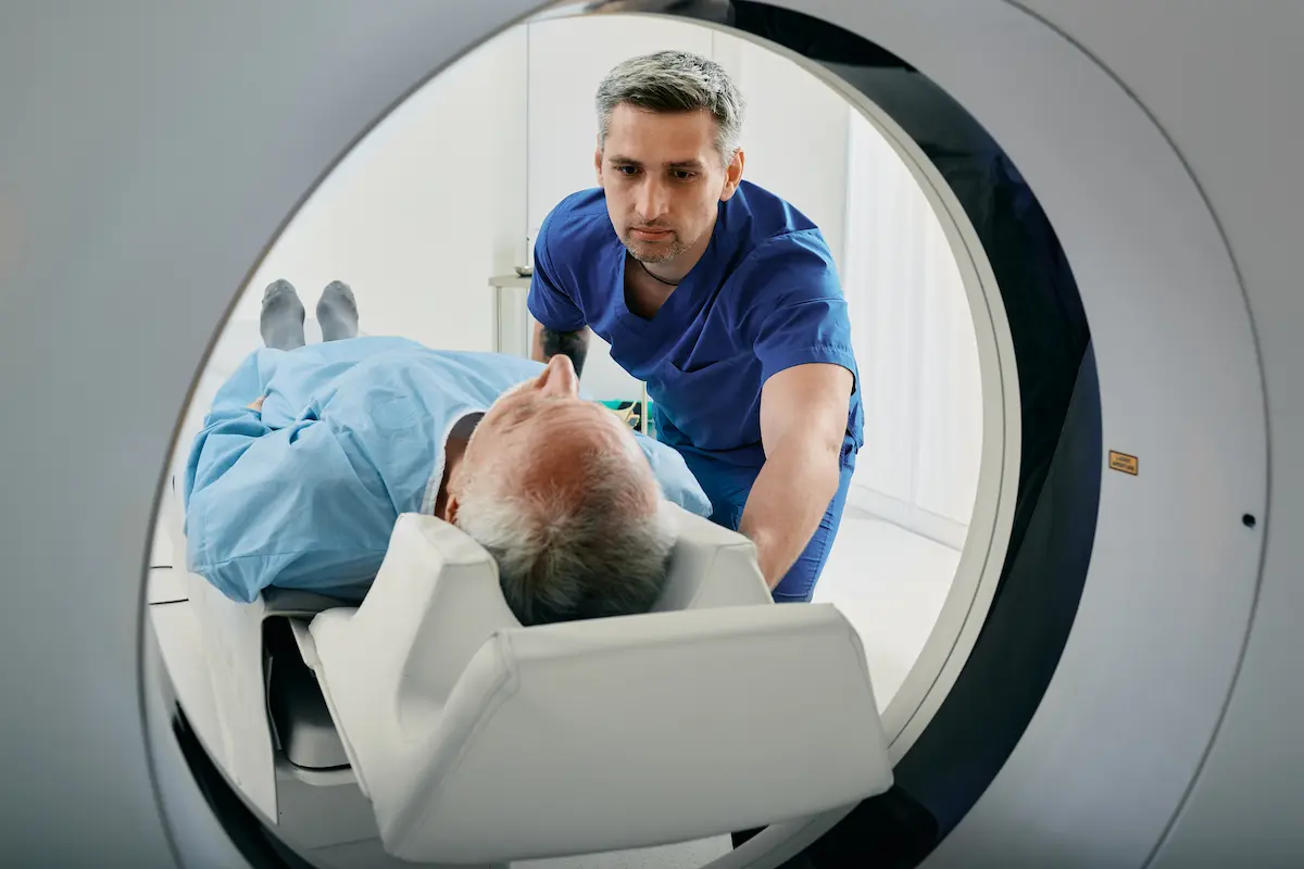 Radiology and imaging MRI tech using an MRI machine on a patient