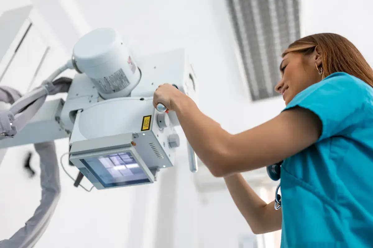 Radiologic tech setting up imaging equipment