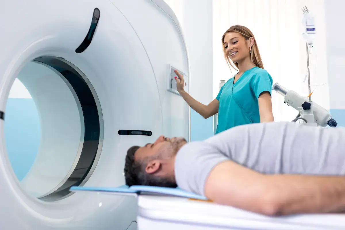 CT tech operating a medical imaging machine