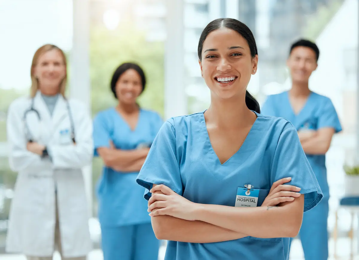 Nurse standing in front of healthcare professional crossing their arms in the hospital.