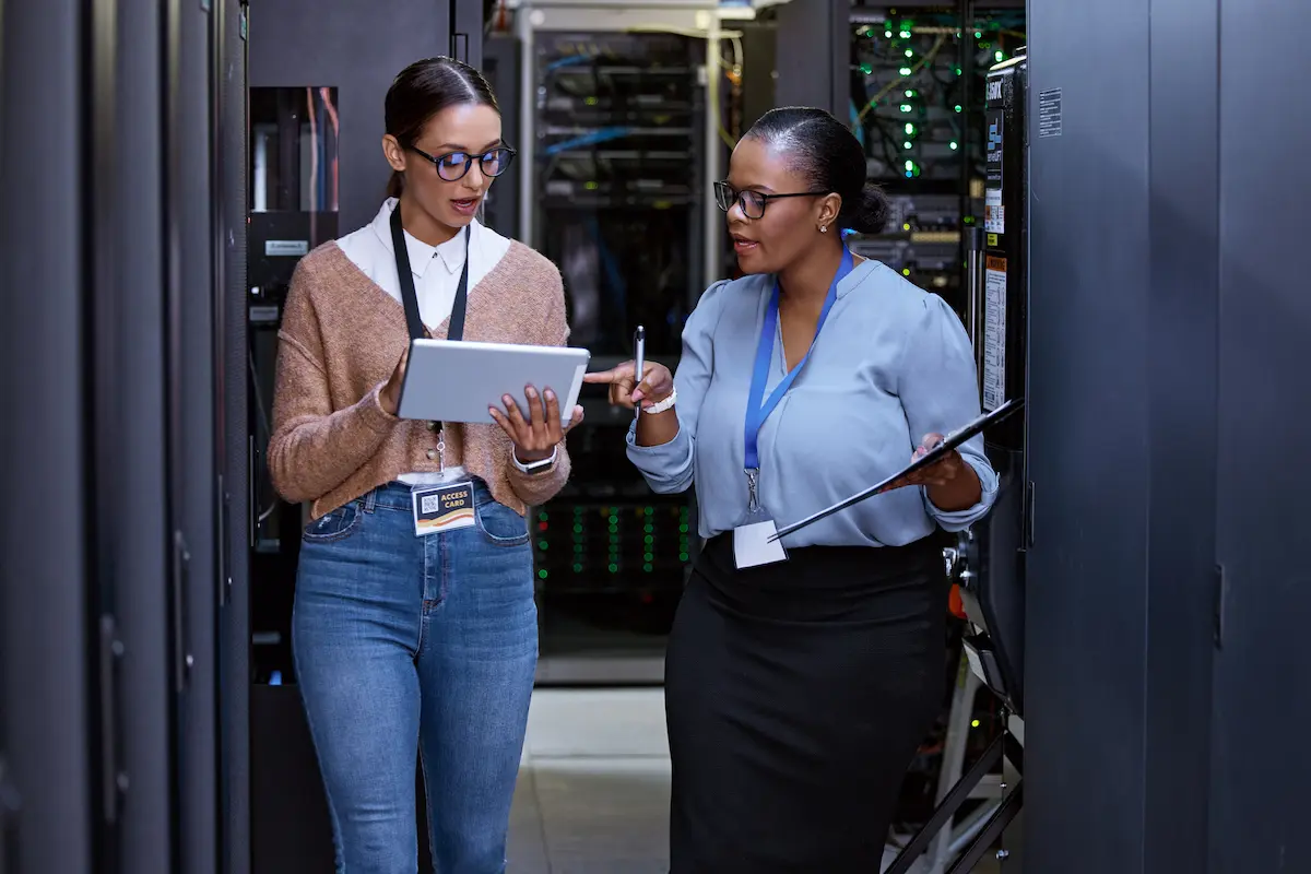 Two non-clinical IT professionals walking and having a conversation at work