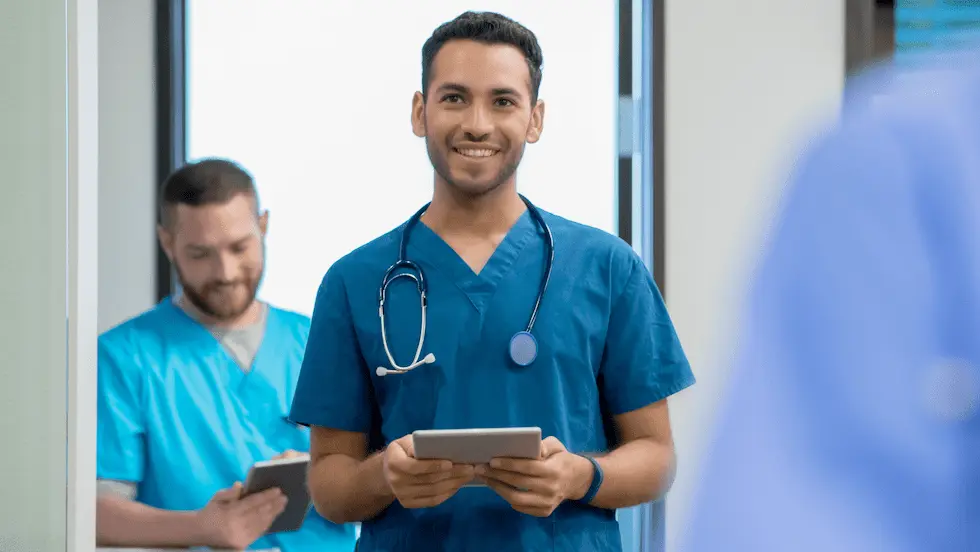 Male nurse working in a hospital with a stethoscope and clipboard