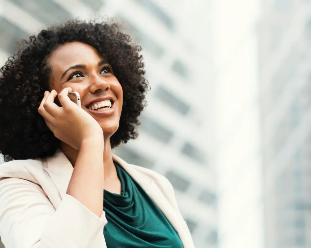 Per diem nurse talking on the phone in front of a building